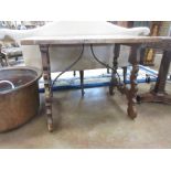 An antique rustic Table with rectangular top on shaped supports and iron shaped stretchers, 3ft
