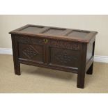 A 17th Century small oak Coffer with three panel lid above tulip carved frieze and pair of diamond