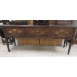 An antique oak Dresser Base fitted three frieze drawers on squared supports, 6ft 2in W