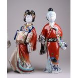 Two large Japanese Kutani female Figures, Meiji Period, both wearing embroidered kimonos, one in a