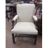 A Georgian mahogany framed Elbow Chair in the manner of Chippendale with upholstered back, seat