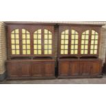 A pair of Arts & Crafts oak Bookcases with wide cornices above astragal glazed doors and two pairs