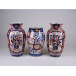 Three Japanese Imari Vases, Meiji Period, comprising a pair of ribbed vases, 12in H, and a baluser