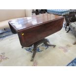 A Regency mahogany Pembroke Table with cross-banded top on square column and reeded quadruple