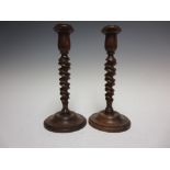 A pair of 19th Century carved walnut Candlesticks with double spiral columns on circular bases, 9