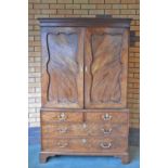 A George III mahogany Linen Press of Chippendale design with pair of shaped panelled doors enclosing