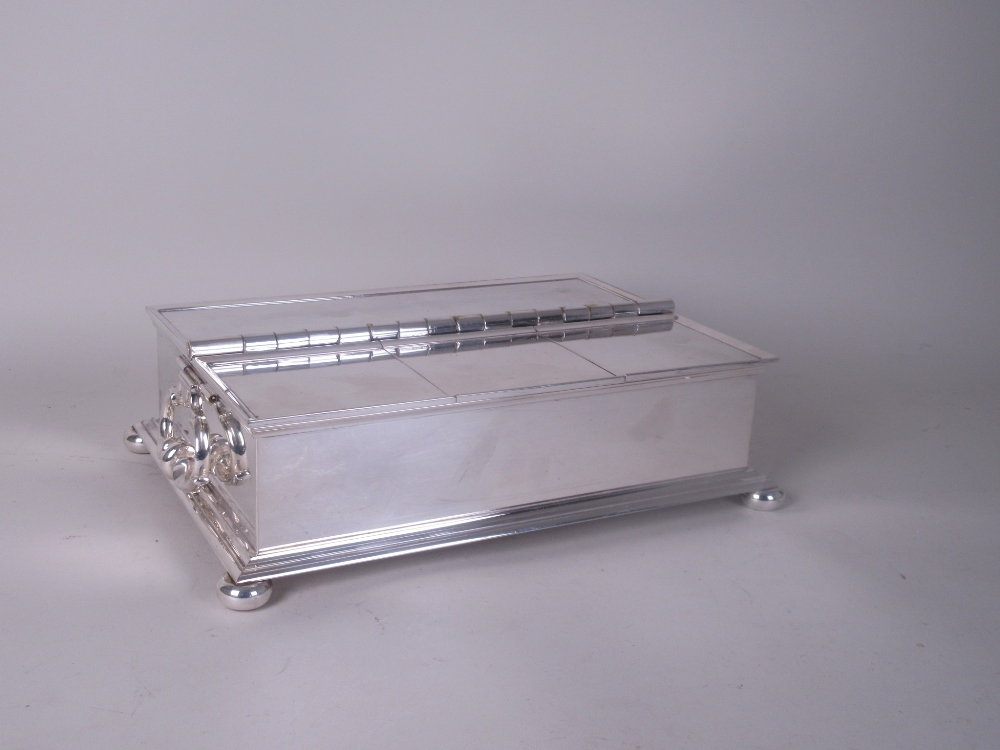 A silver plated Treasury Desk Stand by Lucas of rectangular form with double hinged compartments,