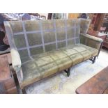 A 19th Century upholstered wing back Settee on six turned supports and casters, 6ft 3in W