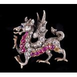 A Ruby and Diamond Dragon Brooch with sapphire cabochon eye, set throughout old and rose-cut