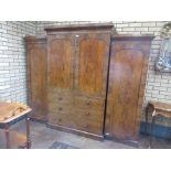 A 19th Century mahogany Breakfront Wardrobe with pair of solid panelled doors flanking smaller