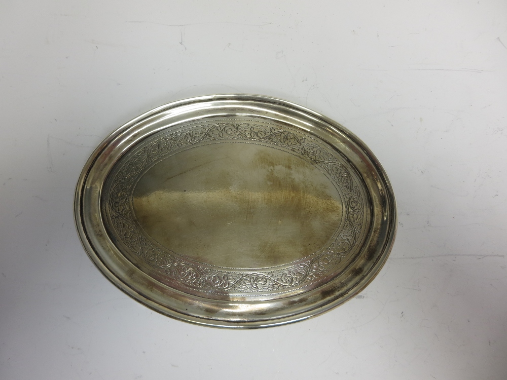 A George III Irish silver oval Teapot Stand with floral and leafage engraved frieze on shaped