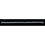 An Aquamarine and Diamond Line Bracelet claw-set twenty oval-cut aquamarines, total weight 14cts,