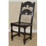 A 17th Century Derbyshire oak Side Chair with double scroll carved frieze, solid seat on turned