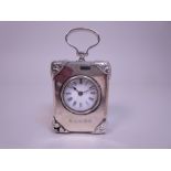 A Victorian silver cased miniature Carriage Clock with white enamel circular dial, ornate corner