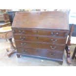 A George III mahogany Bureau with fitted interior above four long graduated drawers on bracket