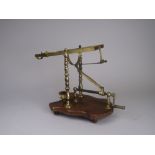 A 19th Century brass Decanting Cradle on shaped wooden base