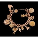 A 9ct gold curblink Bracelet on padlock fastener with numerous charms and Victorian Half Sovereign