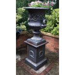 A pair of cast iron Garden Urns, half gadrooned with scrolling acanthus and reeded handles with mask