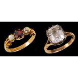 A Ruby and Diamond three stone Ring claw-set round ruby between two old-cut diamonds in 18ct gold,