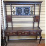 An antique oak Cottage Dresser and Rack, the base fitted three drawers on cabriole front supports