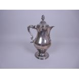 A George III silver Hot Water Jug of baluster form with gadroon friezes, acorn finial, leafage