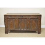 A 17th Century oak Coffer with plank lid above gadroon frieze and three diamond, arch carved