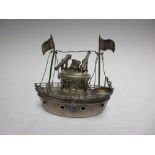 An Indian white metal Model of a Ship with canons, flag and life boats, hinged upper section,