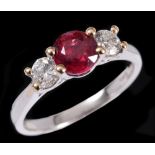 A Ruby and Diamond three stone Ring claw-set round ruby, 0.95cts between two brilliant-cut