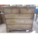 A Georgian mahogany Dressing Chest fitted brushing slide above two short and three long drawers on