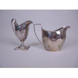 A George III silver helmet shape Cream Jug engraved floral swags and initials, on square base,