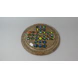 A Circular Wooden Solitaire Game with Vintage Marbles, 26cm Diameter