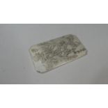 A White Metal Ingot Slab Cast in Relief with Dragons Amongst Clouds and Scrolls