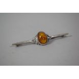 An Amber and Silver Bar Brooch