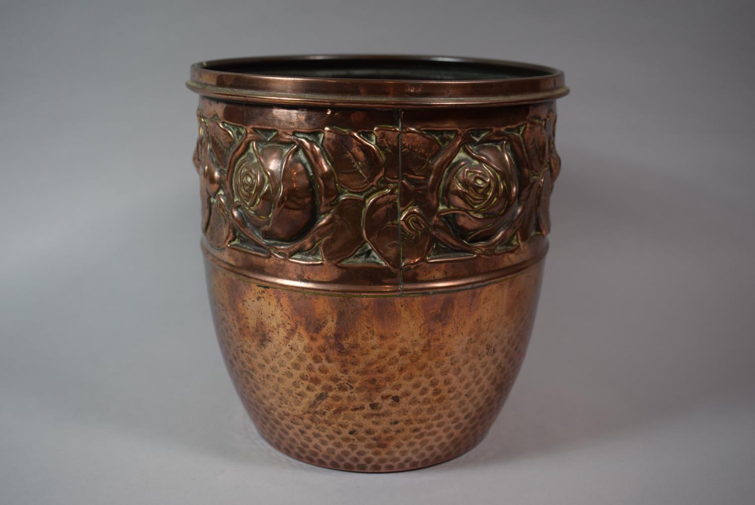 A Hand Beaten Copper Jardiniere with Floral Decoration in Relief, 20cm Diameter