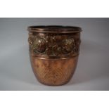 A Hand Beaten Copper Jardiniere with Floral Decoration in Relief, 20cm Diameter