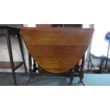 An Edwardian Oak Oval Topped Drop Leaf Gate Legged Dining Table. 87cm Wide