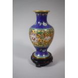 An Oriental Cloisonne Vase Decorated in Multi Coloured Enamels and With Circular Wooden Stand,