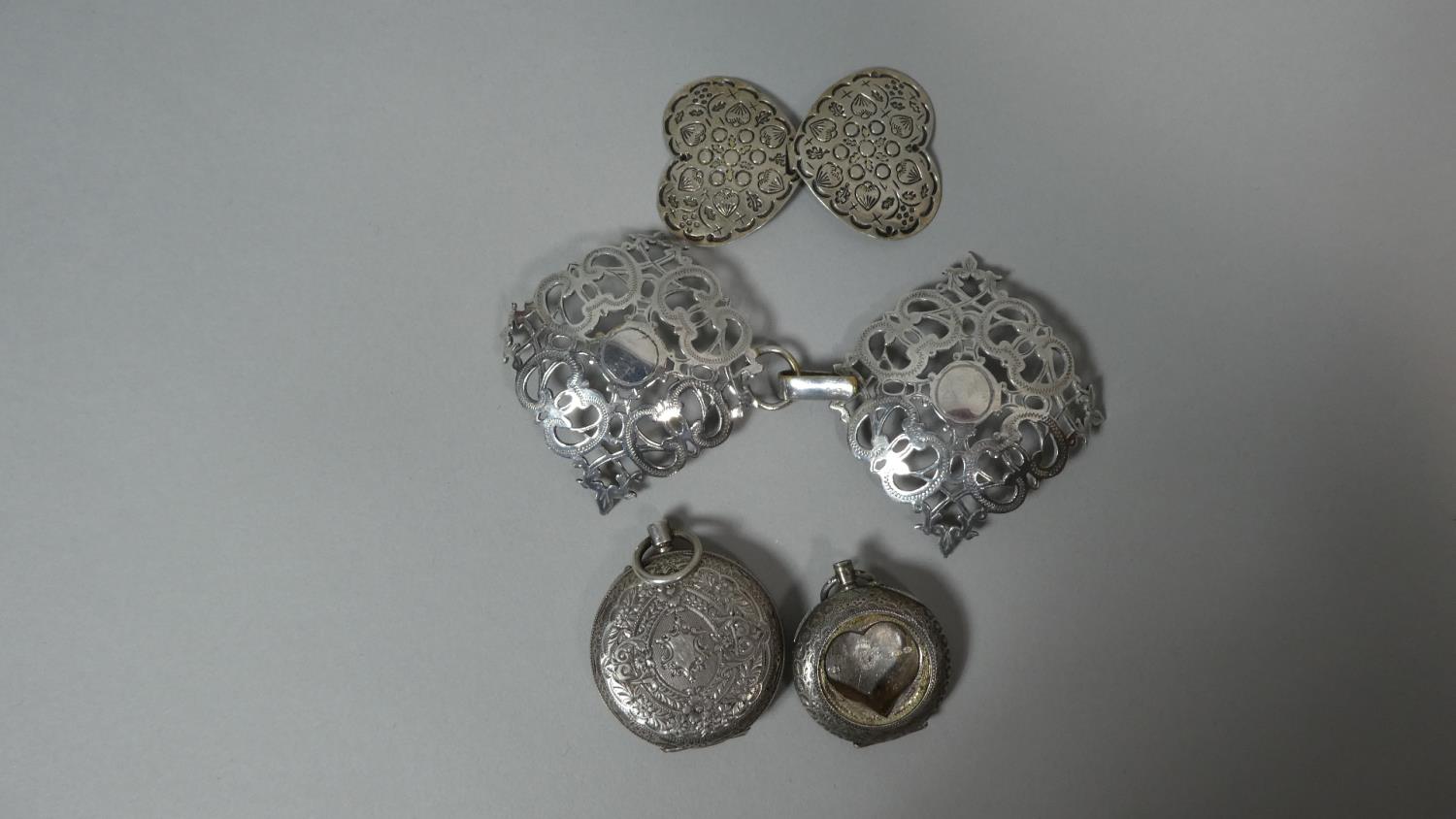 A Ladies Silver Pocket Watch Case, Two Silver Plated Belt Buckles and Another Silver Pocket Watch