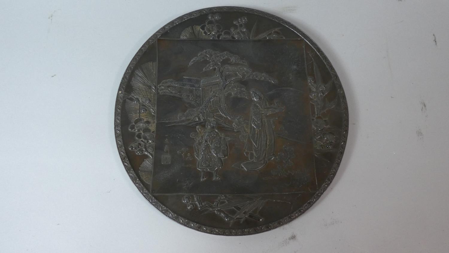 A 19th Century Japanese Circular Bronze Plaque Decorated in Relief with Figures, Willow Trees and