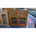 An Edwardian Side Cabinet with Hinged Lid and Glazed Cupboard Base