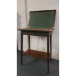 An Edwardian Mahogany Lift and Twist Top Games Table with Beize Playing Surface and Stretcher Shelf,