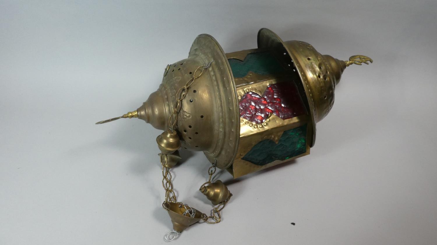 A Turkish Brass Hanging Lantern with Coloured Glass Shade