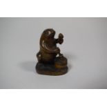 A Japanese Carved Wooden Netsuke in the form of a Frog Banging Taiko, 5.5cm High