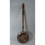 A Copper Bed Warming Pan with Turned Wooden Handle, the Pan Inscribed 1644