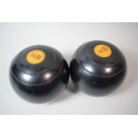 A Bag Containing Two Ebonised Lawn Bowls, Monogrammed HB