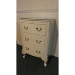 A Cream and Gilt Bow Fronted Three Drawer Bedroom Chest, 75cm High