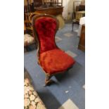 A Victorian Walnut Framed Balloon Back Ladies Nursing Chair (Front Leg Detached)