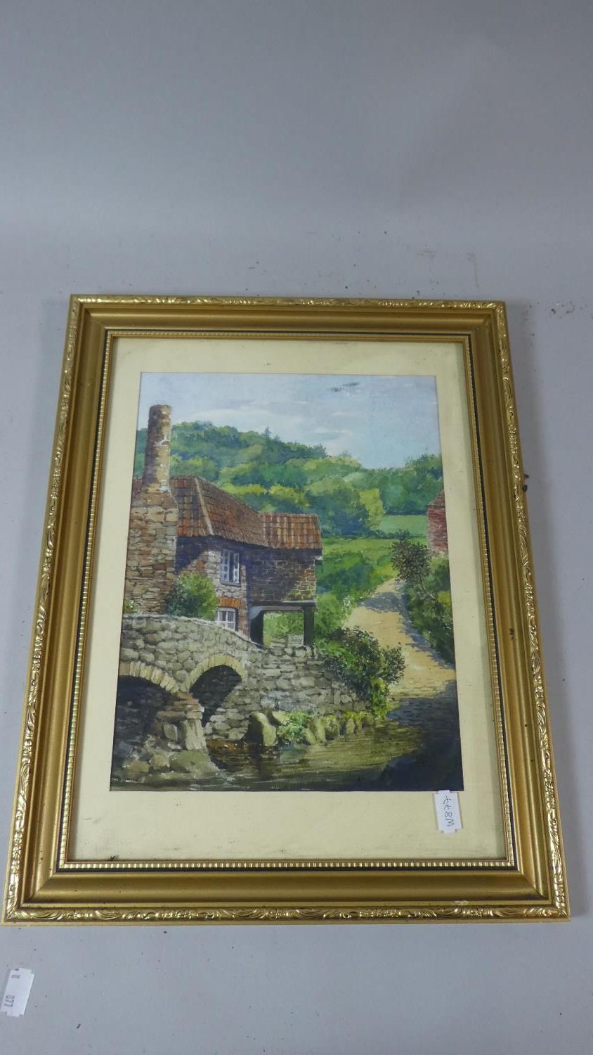 A Framed Water Colour Depicting Mill Cottage Beside River