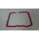A Red Coral Polished String of Beads, 34.9gms