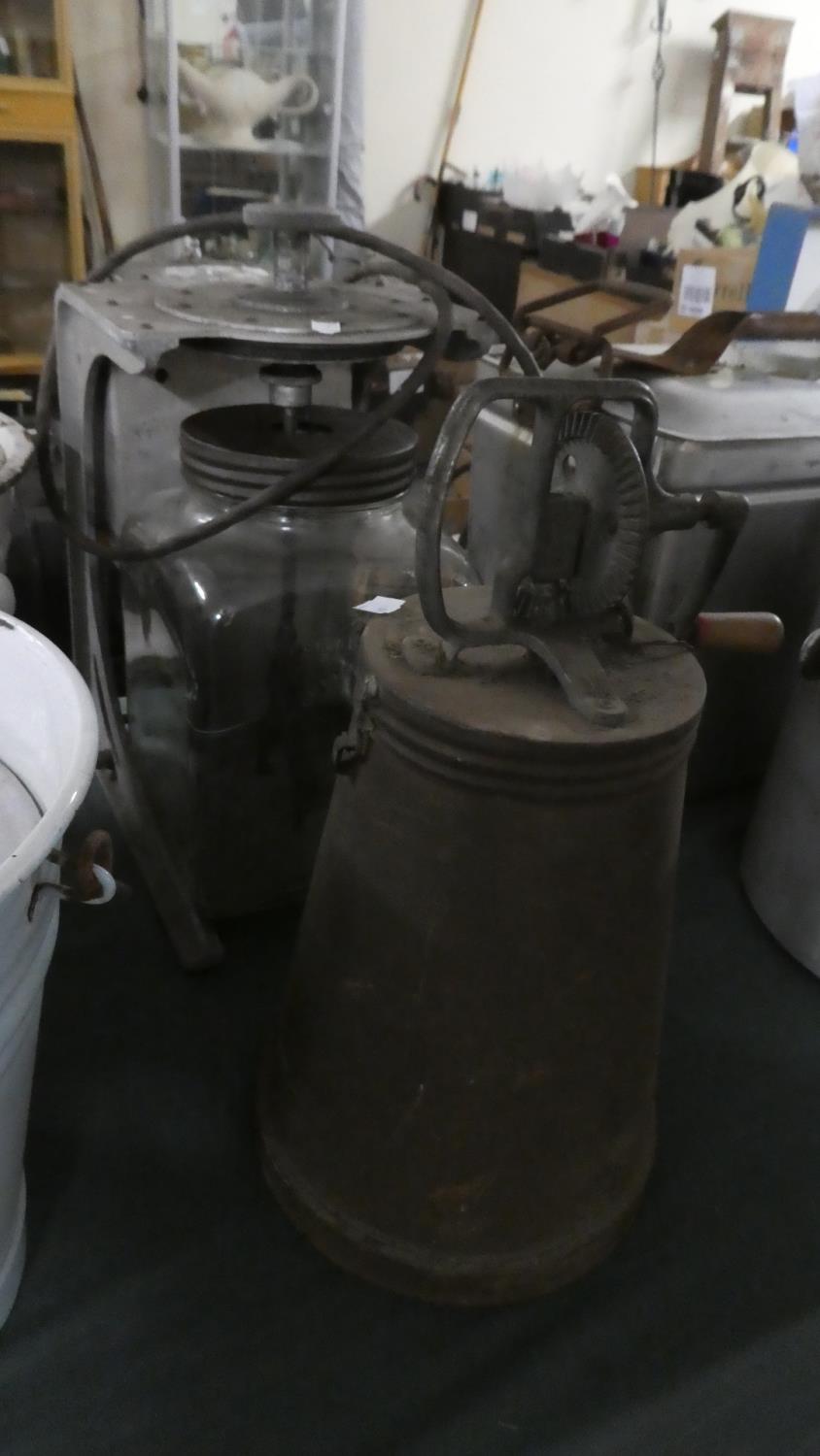 A Vintage Electric Powered Blow Butter Churn Together with a Metal Hand Operated Example
